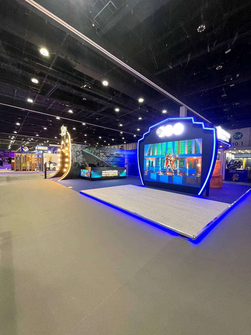 Exhibition stand with illuminated logo and LED-lit platform at an Abu Dhabi event
